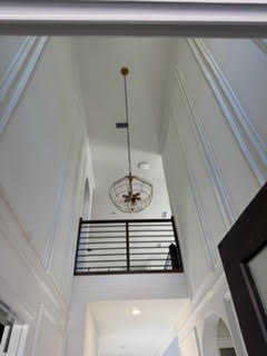 Grand entry hallway with fresh paint and chandelier